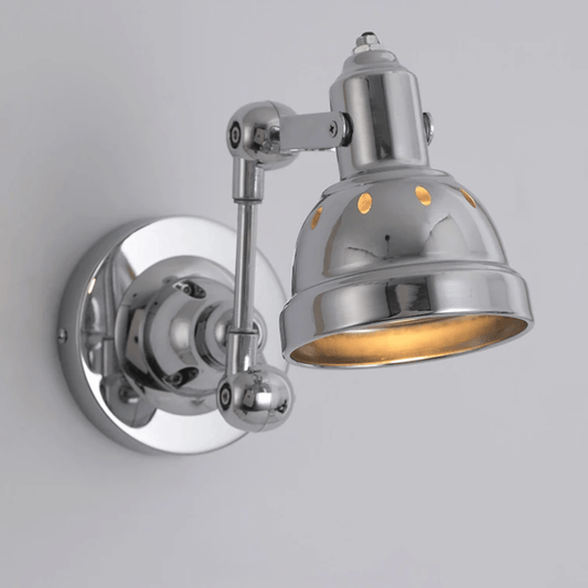 Chrome wall-mounted light fixture on a gray background