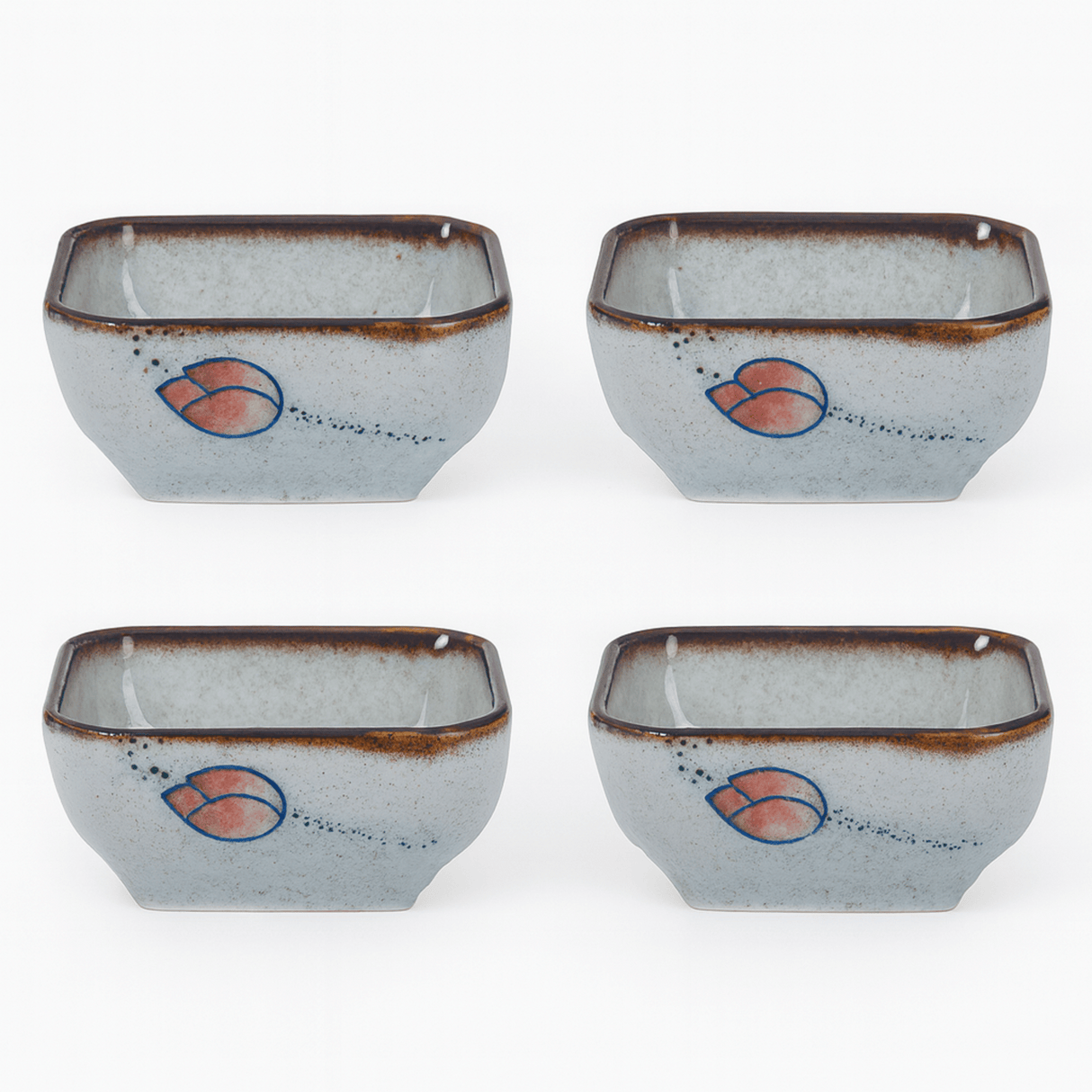 Four ceramic bowls with a decorative design on a white background