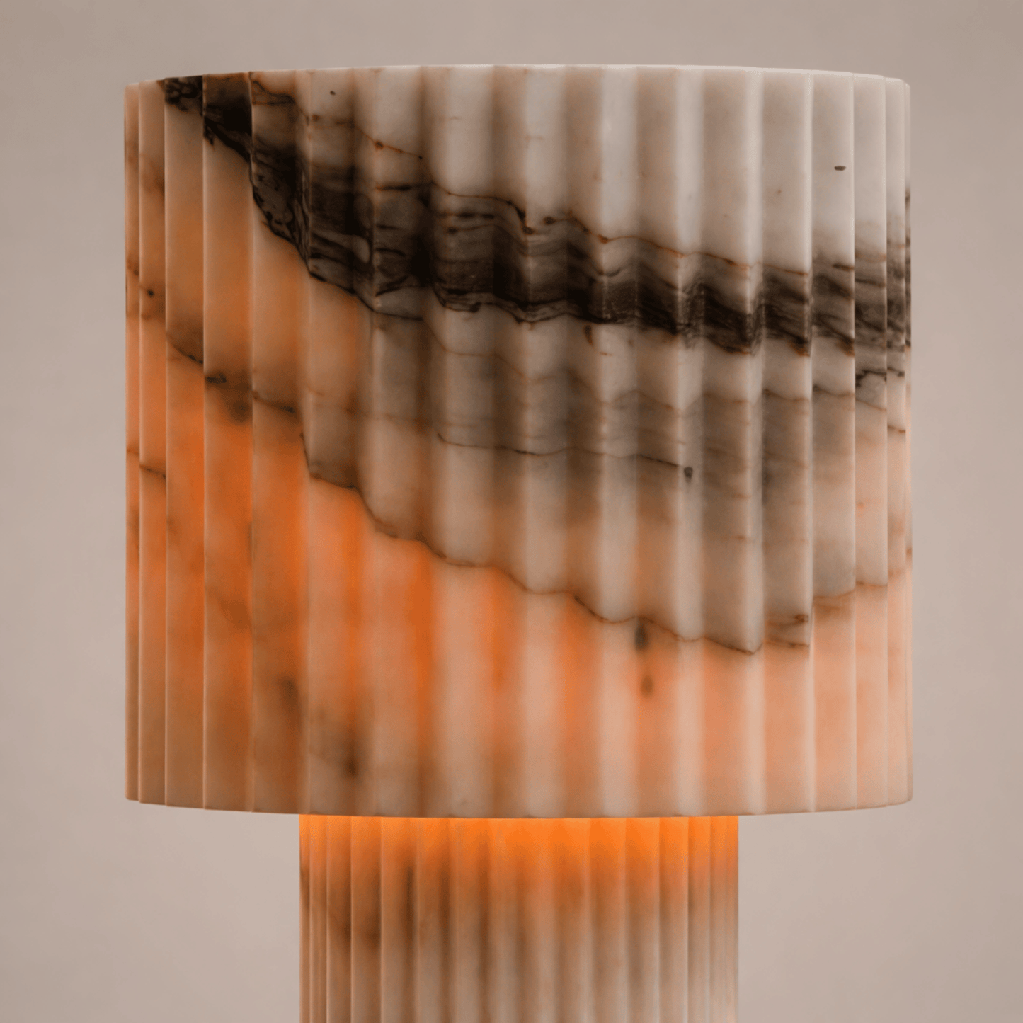 Marble-patterned lamp with warm tones on a neutral background