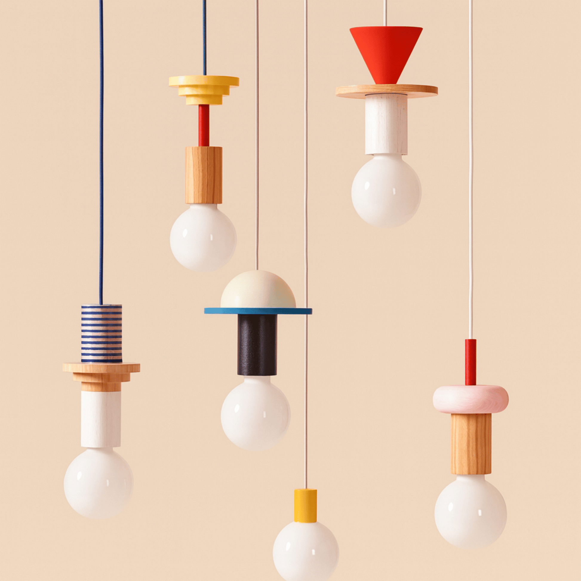 Colorful pendant lights with geometric designs on a beige background