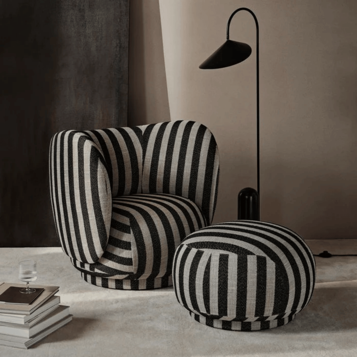 Black and white striped armchair and ottoman in a modern interior setting.