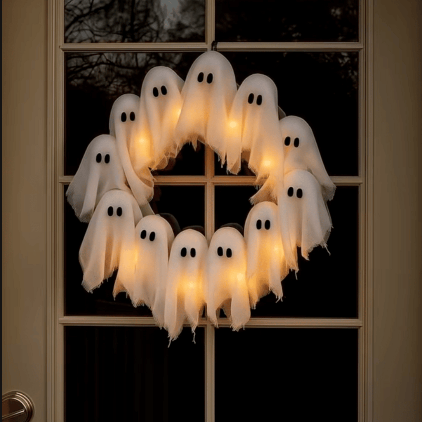 Halloween wreath with ghost decorations on a door
