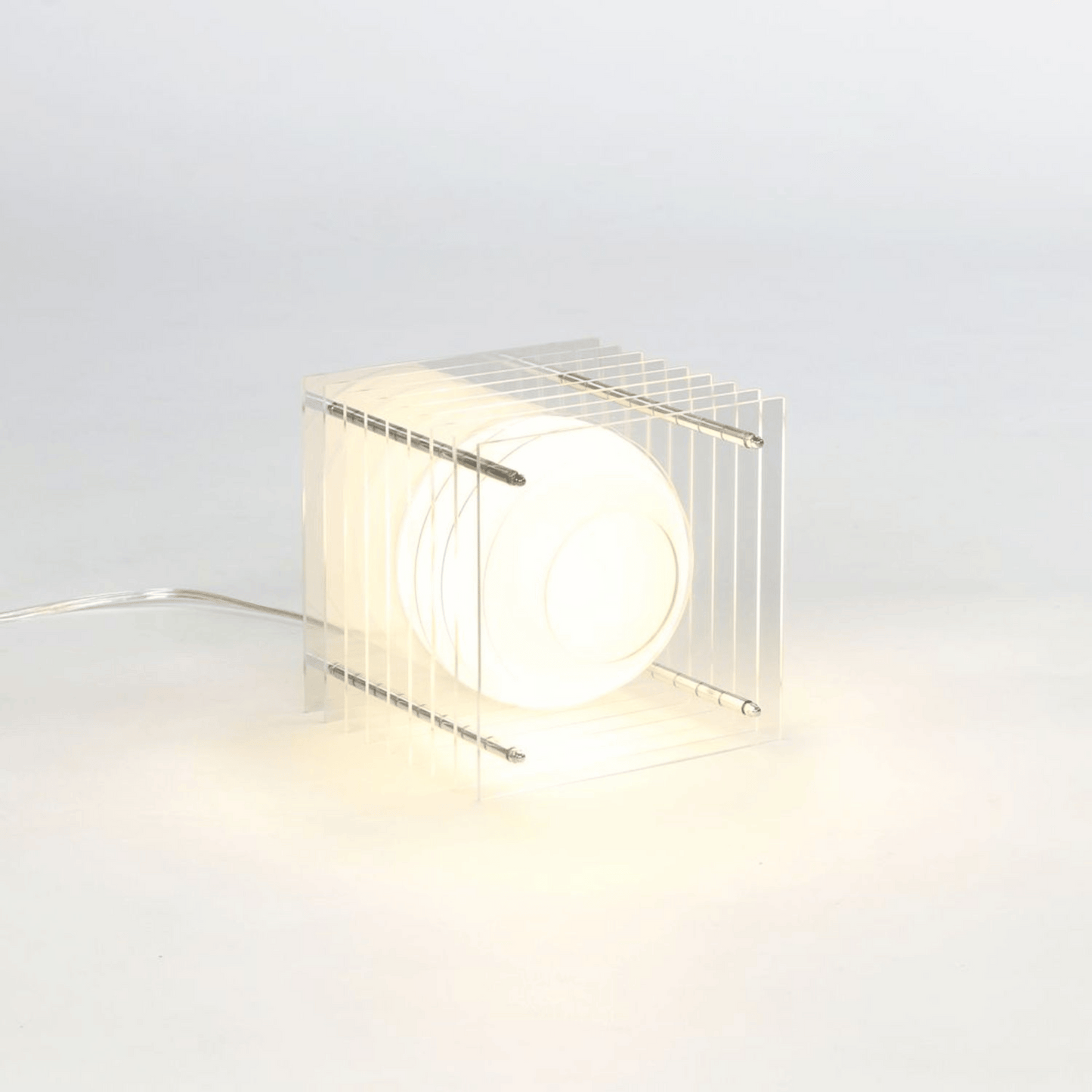 Modern table lamp with wire cage design on a light gray background