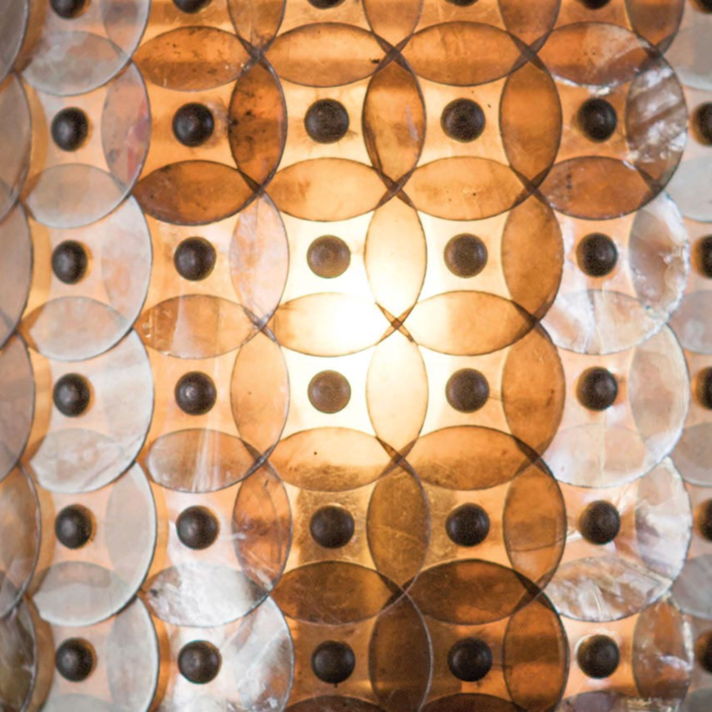 Close-up of a decorative wall panel with circular patterns and metallic sheen.