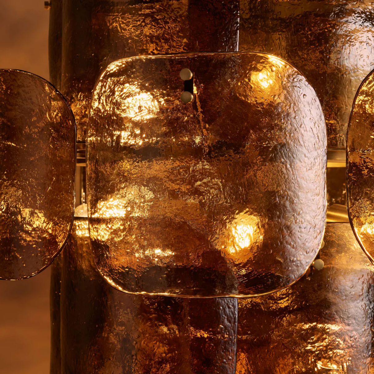 Close-up of a textured metallic object with a warm glow