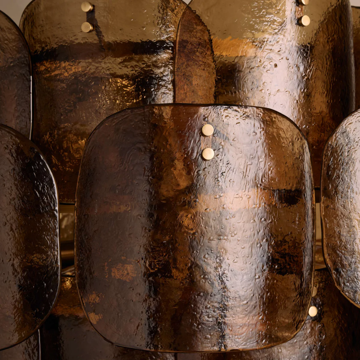 Close-up of a textured metallic surface with a focus on the material's sheen and color variations.