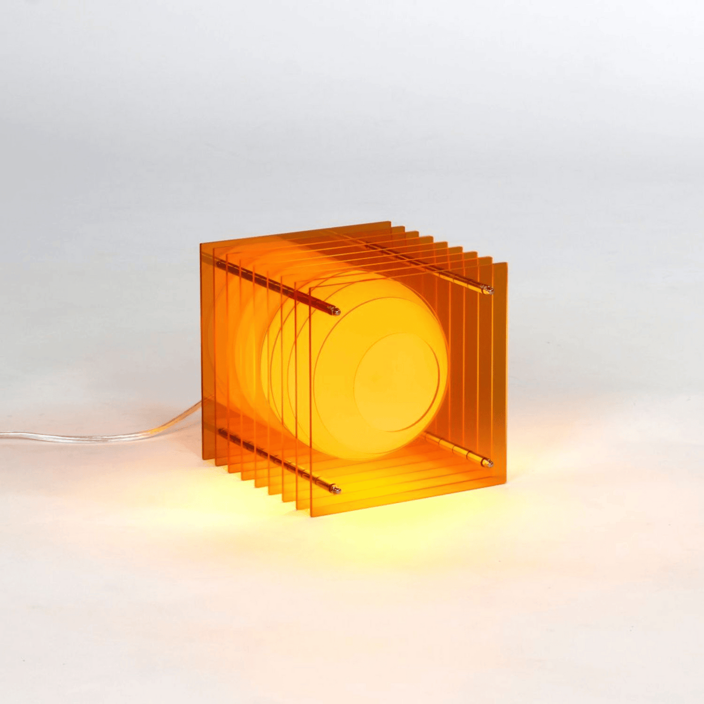 Orange transparent cube lamp on a white background
