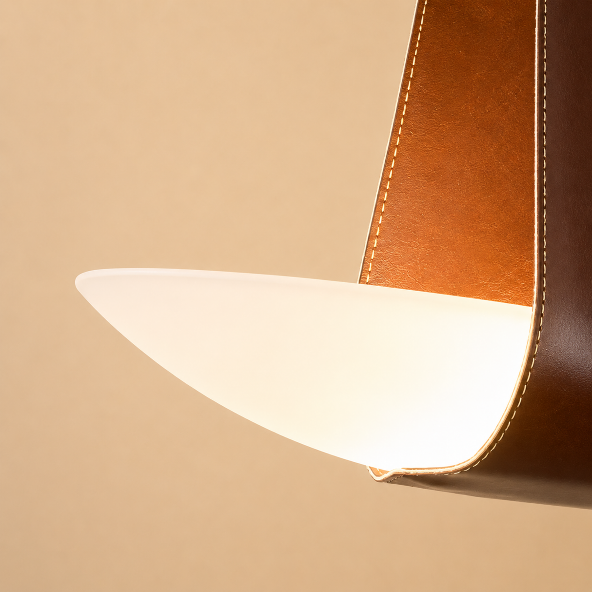 Close-up of a brown leather product with a white interior on a beige background
