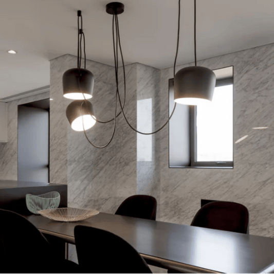 Modern dining area with pendant lights and marble walls