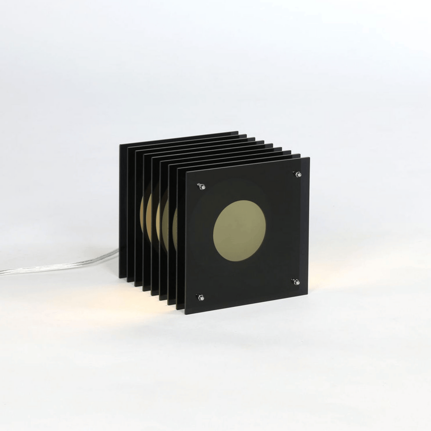 Set of black square coasters with a central circular design on a white background