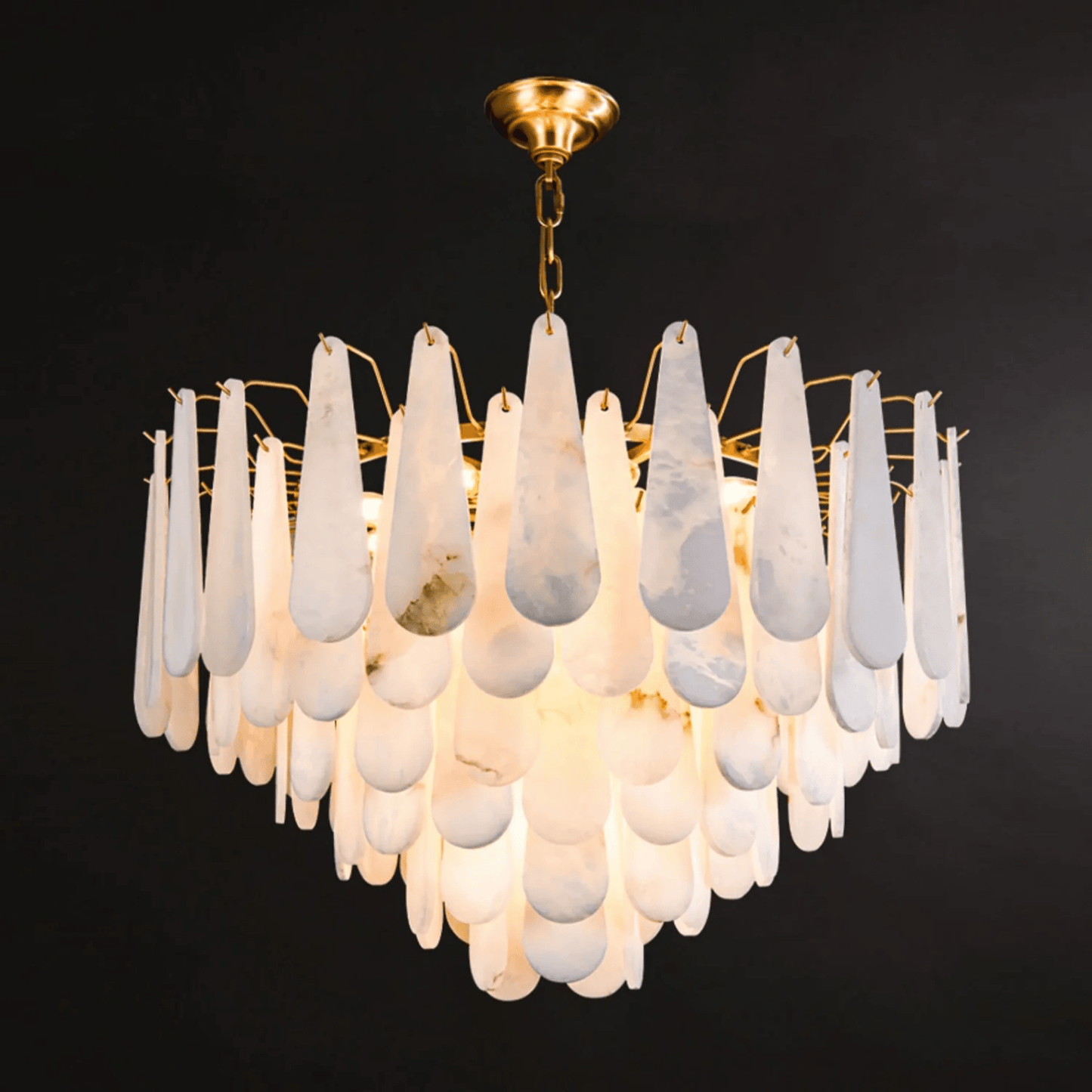 Chandelier with white teardrop-shaped glass shades on a black background