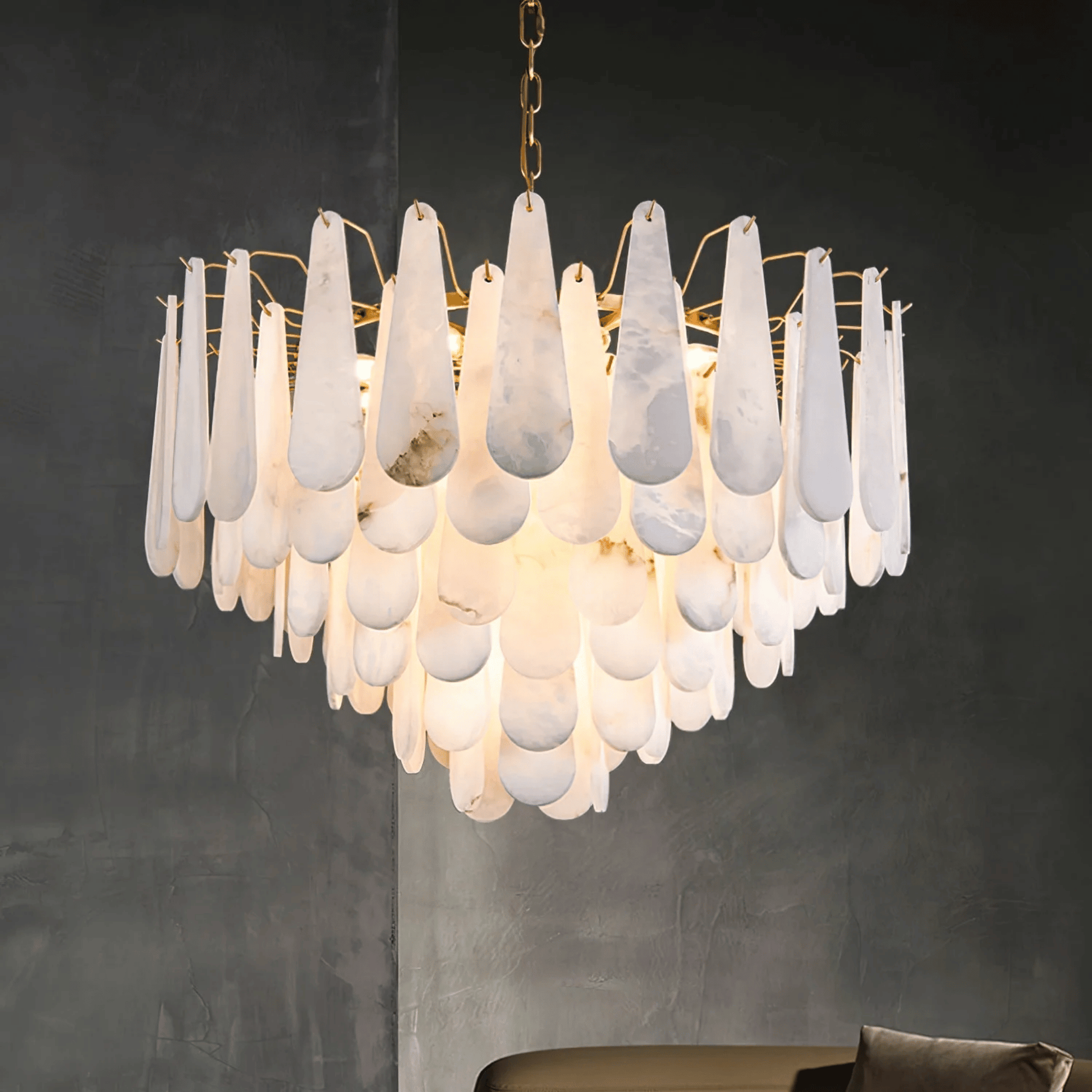 Chandelier with white teardrop-shaped glass shades on a dark background