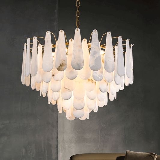 Chandelier with white teardrop-shaped glass shades on a dark background