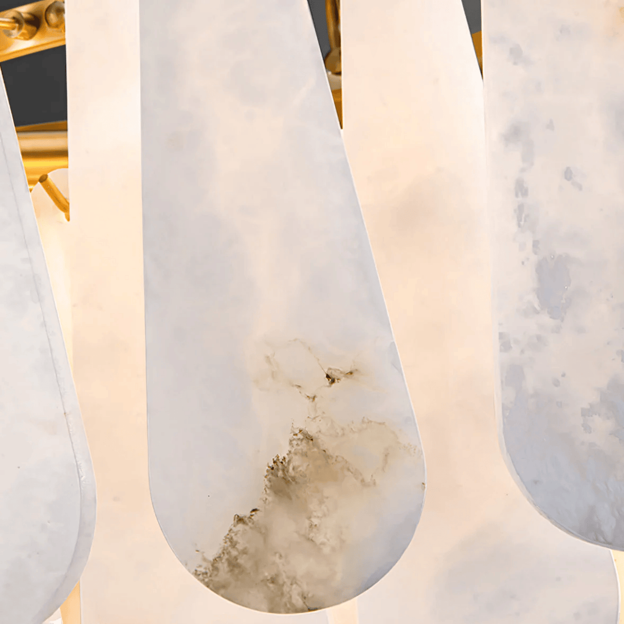 Close-up of marble-textured white shoes with a gold frame in the background