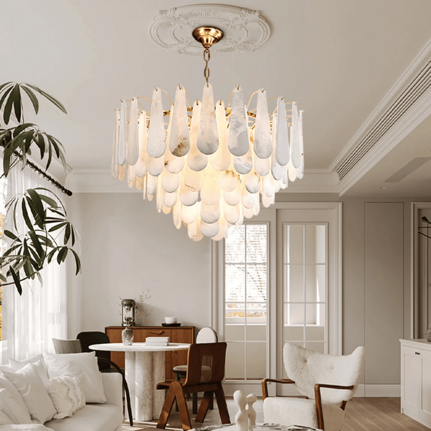 Modern chandelier hanging in a stylish living room with a dining table and chairs.