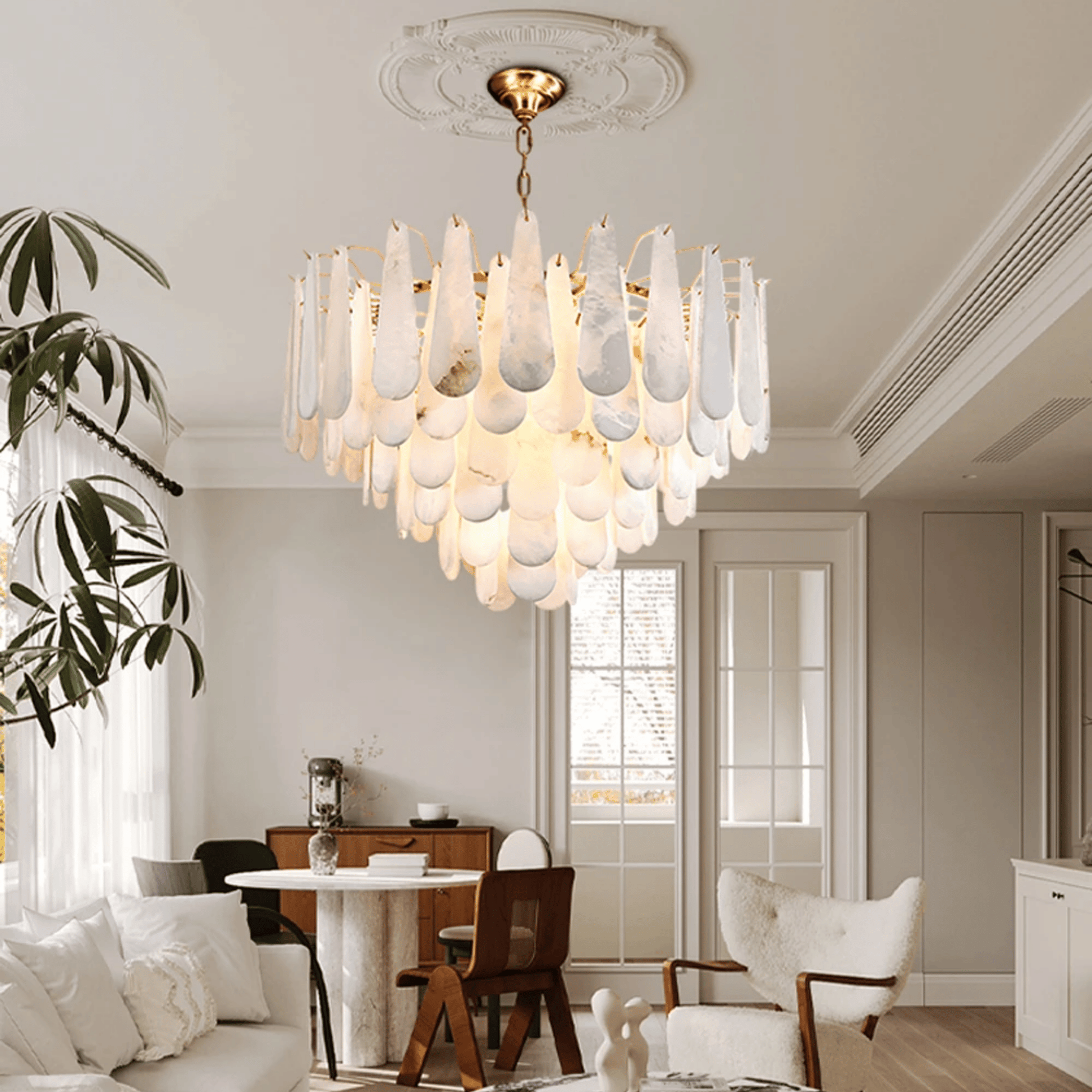 Modern chandelier hanging in a stylish living room with a dining table and chairs.