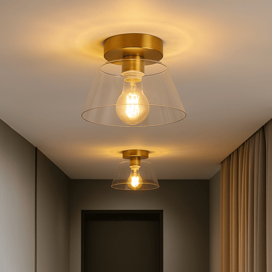 Gold ceiling lights with clear glass shades on a ceiling.