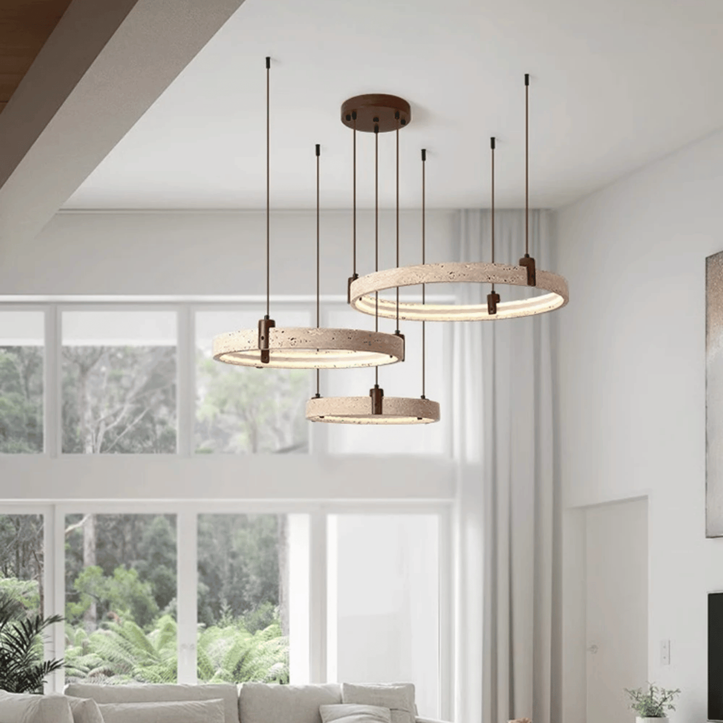Modern pendant lights hanging in a living room with large windows.