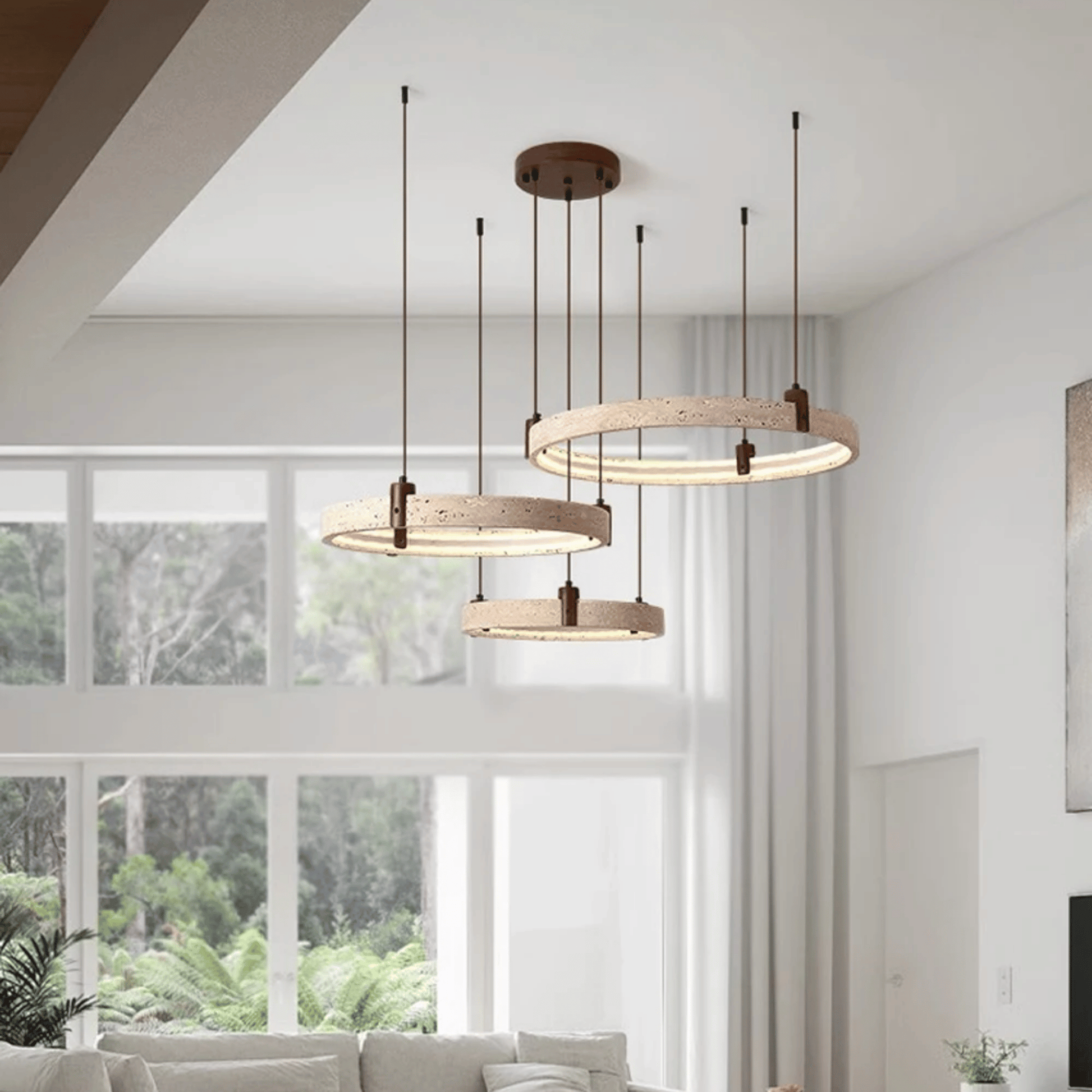 Modern pendant lights hanging in a living room with large windows.