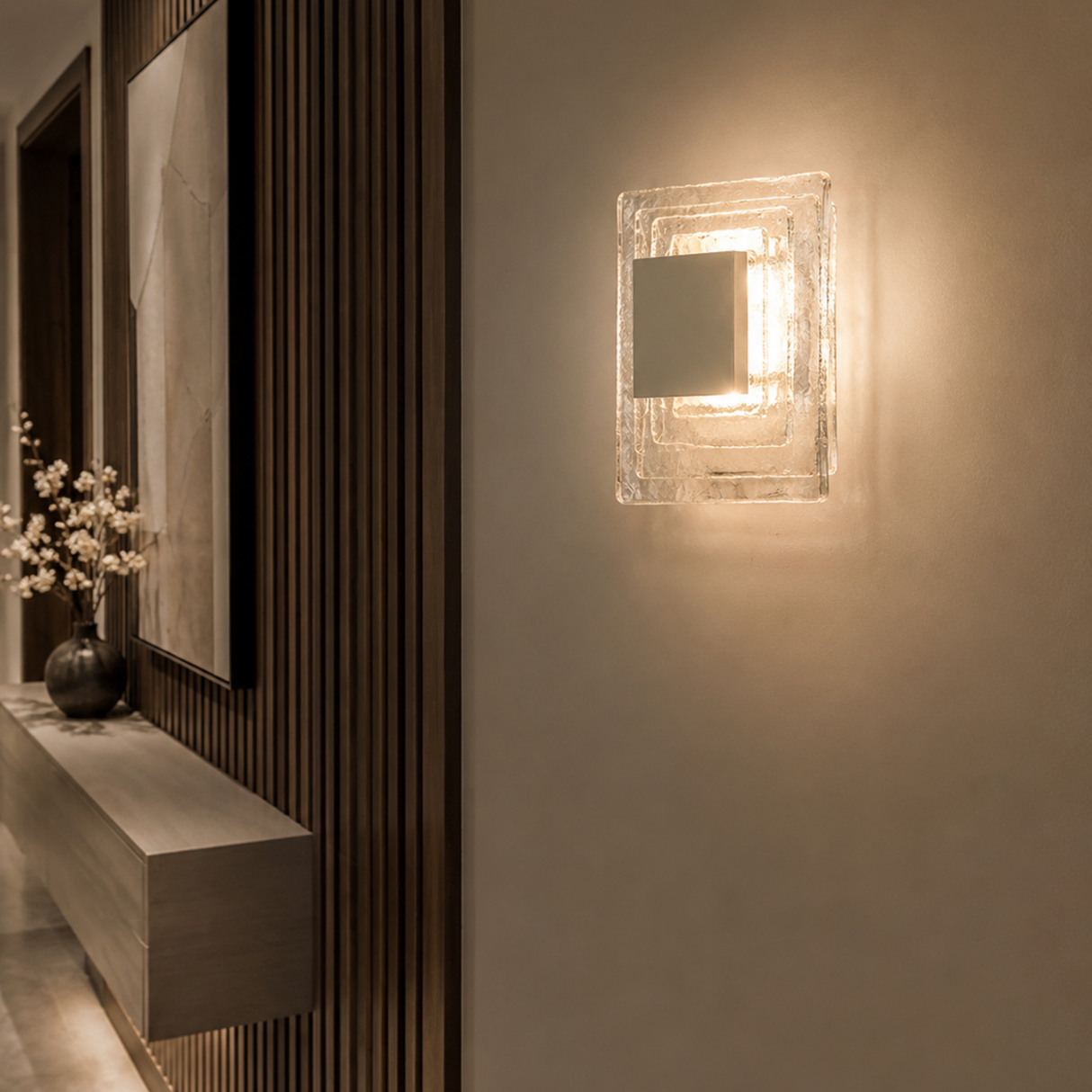 Modern wall sconce lighting fixture on a neutral wall with decorative elements.