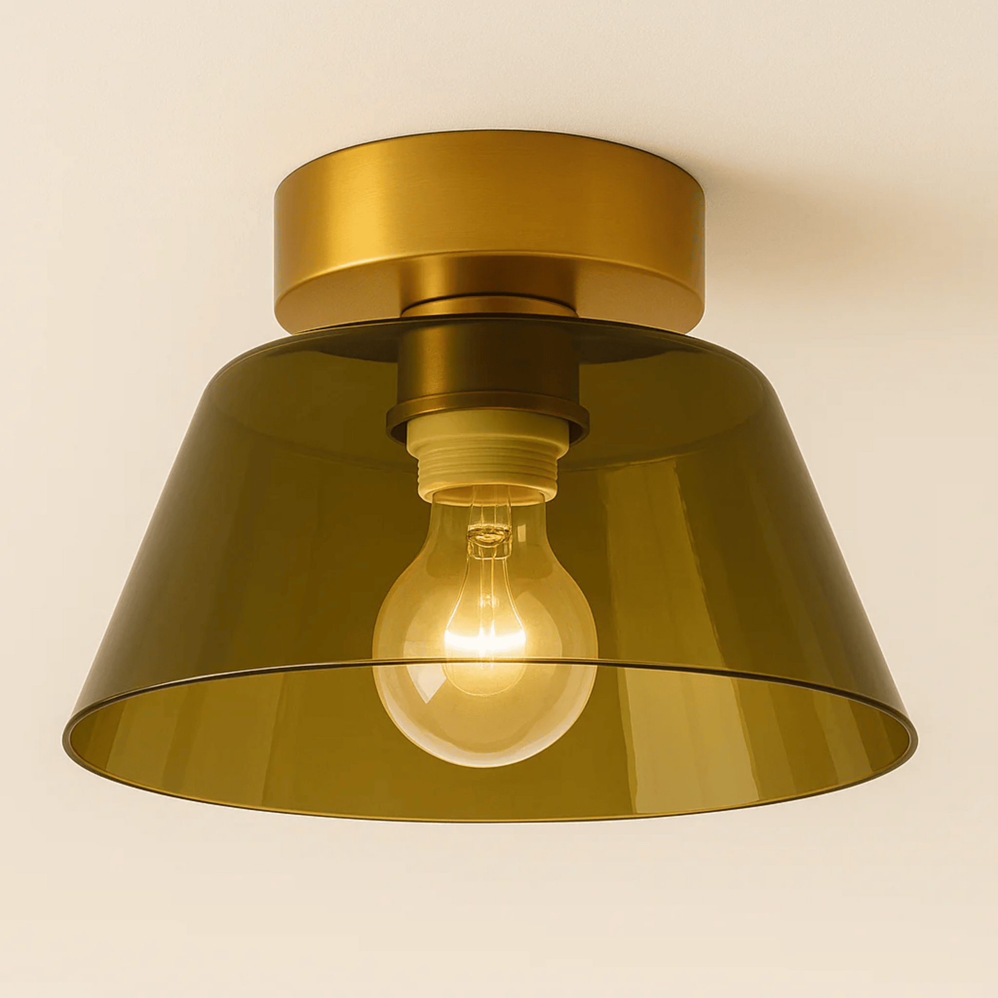 Gold ceiling light fixture with a visible light bulb on a beige background