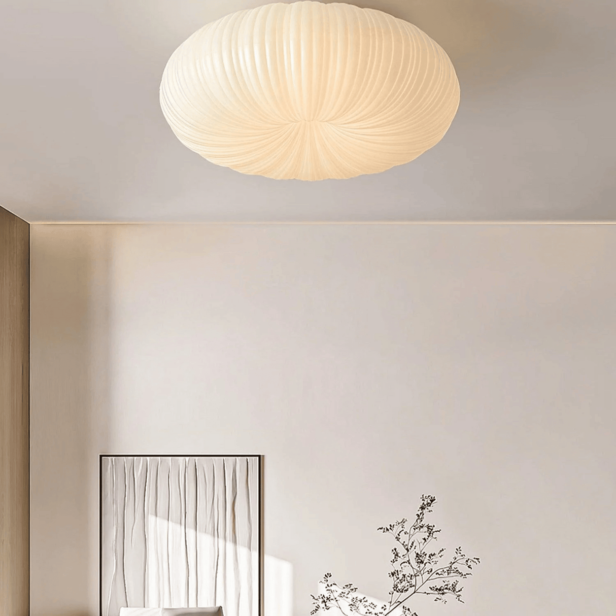 Ceiling light fixture in a room with a mirror and decorative plant