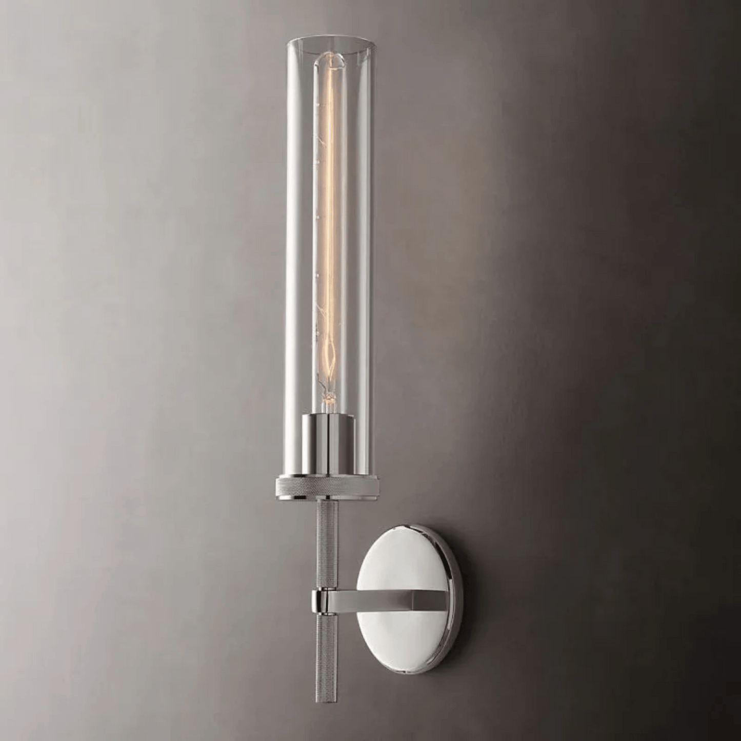Modern wall sconce with cylindrical design on a gray wall