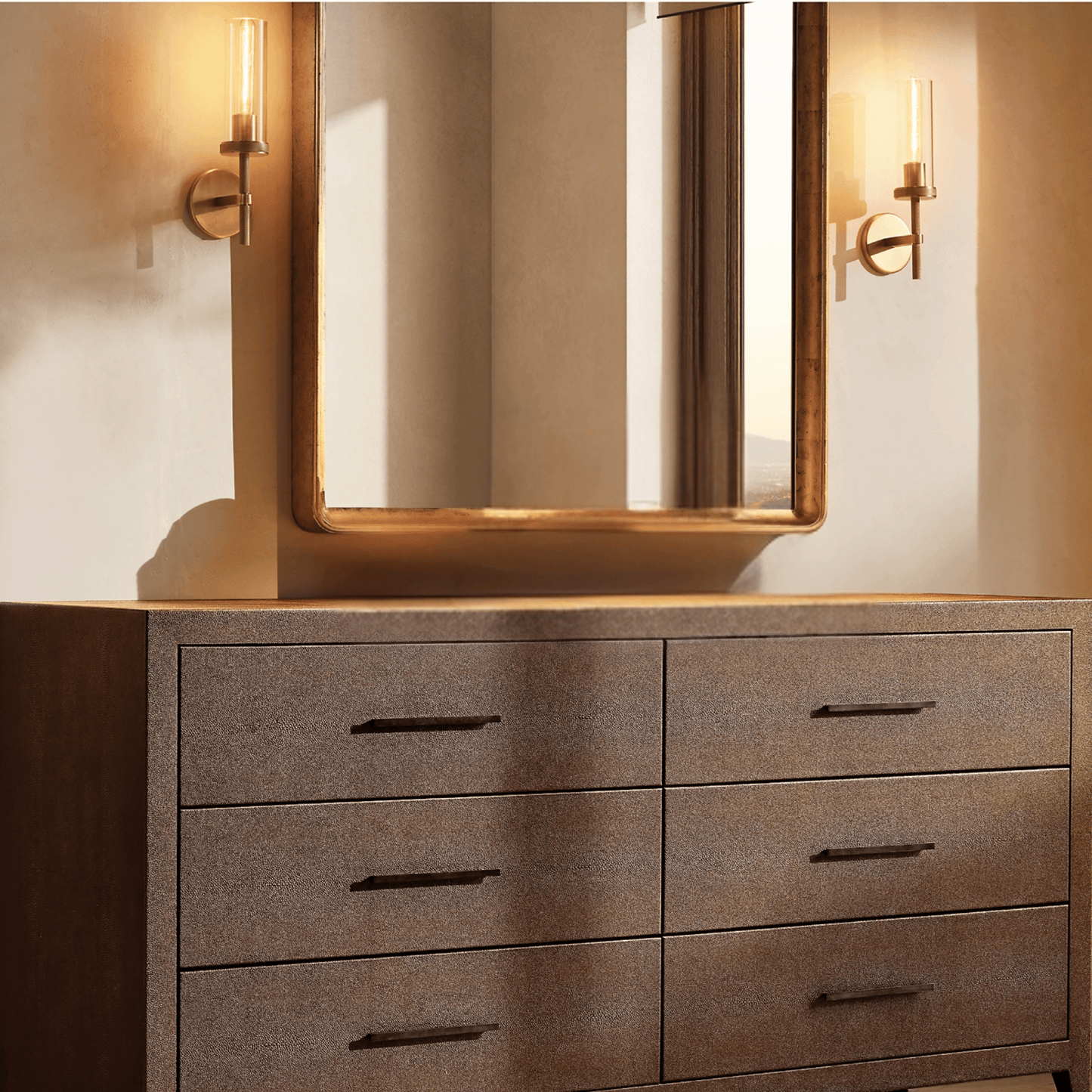 Bathroom vanity with large mirror, lights, and textured drawers.