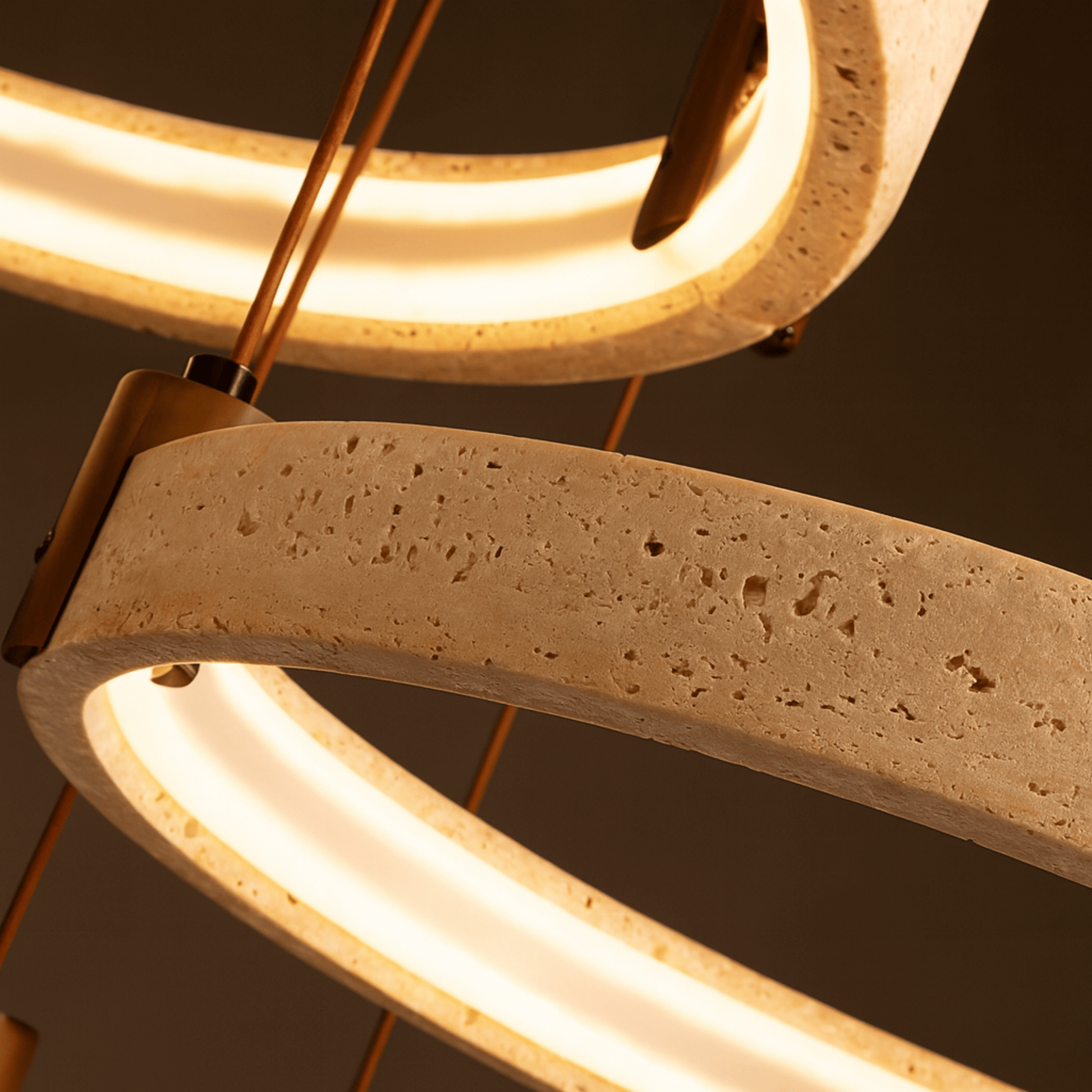 Close-up of a modern light fixture with concrete-like design on a dark background