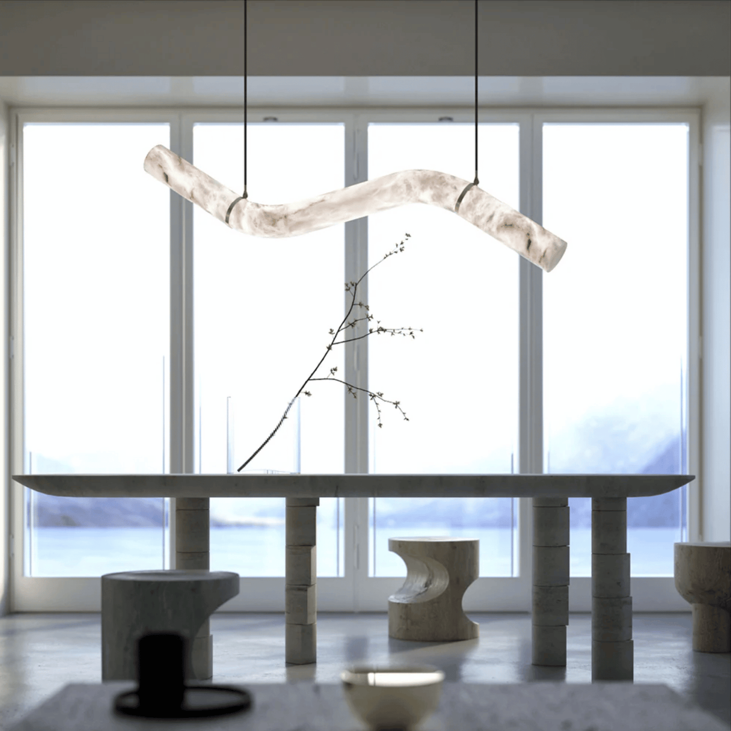 Modern interior with a long dining table and abstract light fixture.