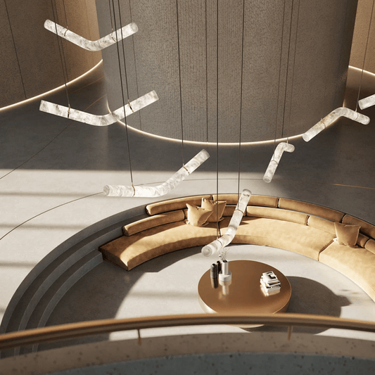 Modern circular seating area with beige cushions and a round table, featuring hanging light fixtures.