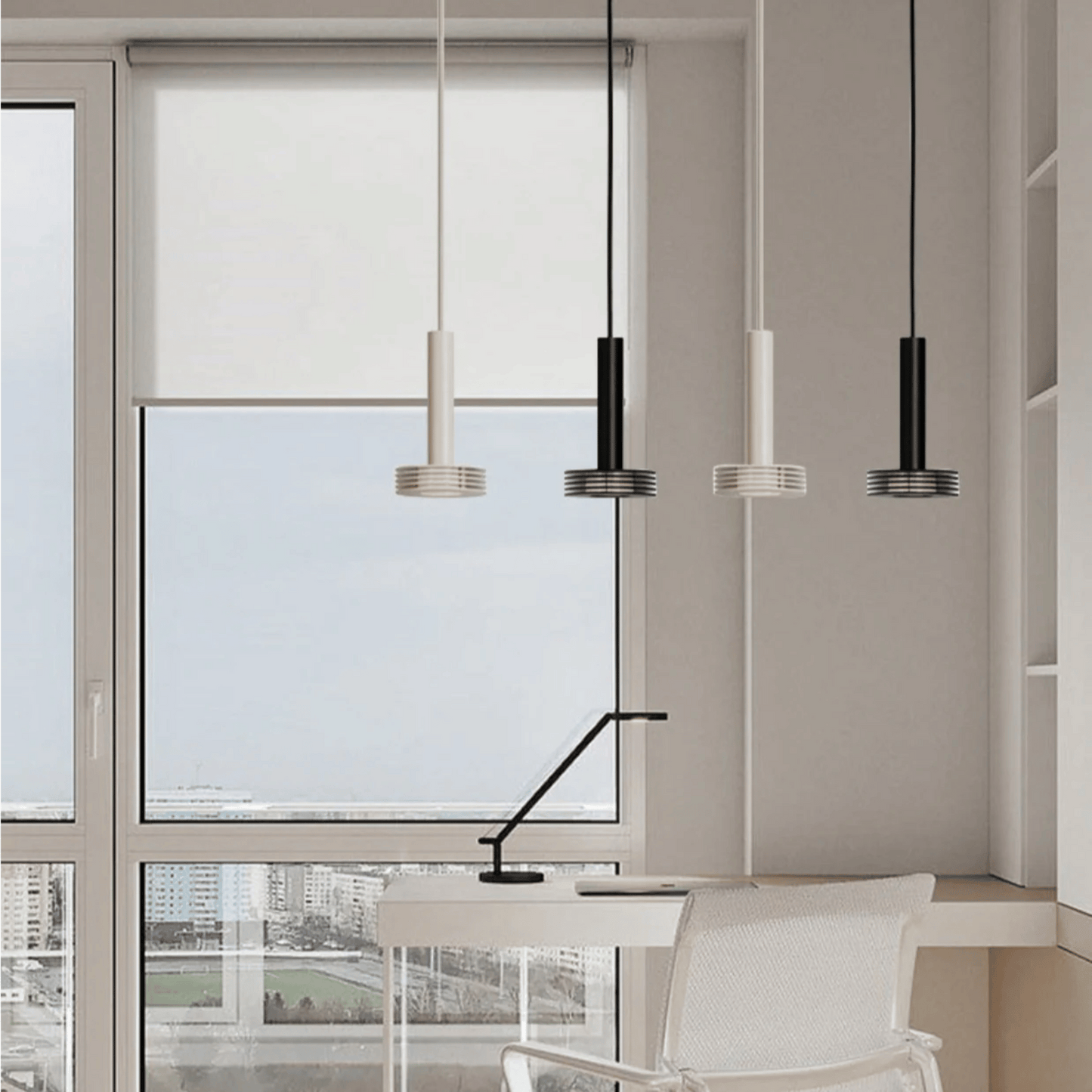 Modern office setup with pendant lights, desk, and chair near a large window.
