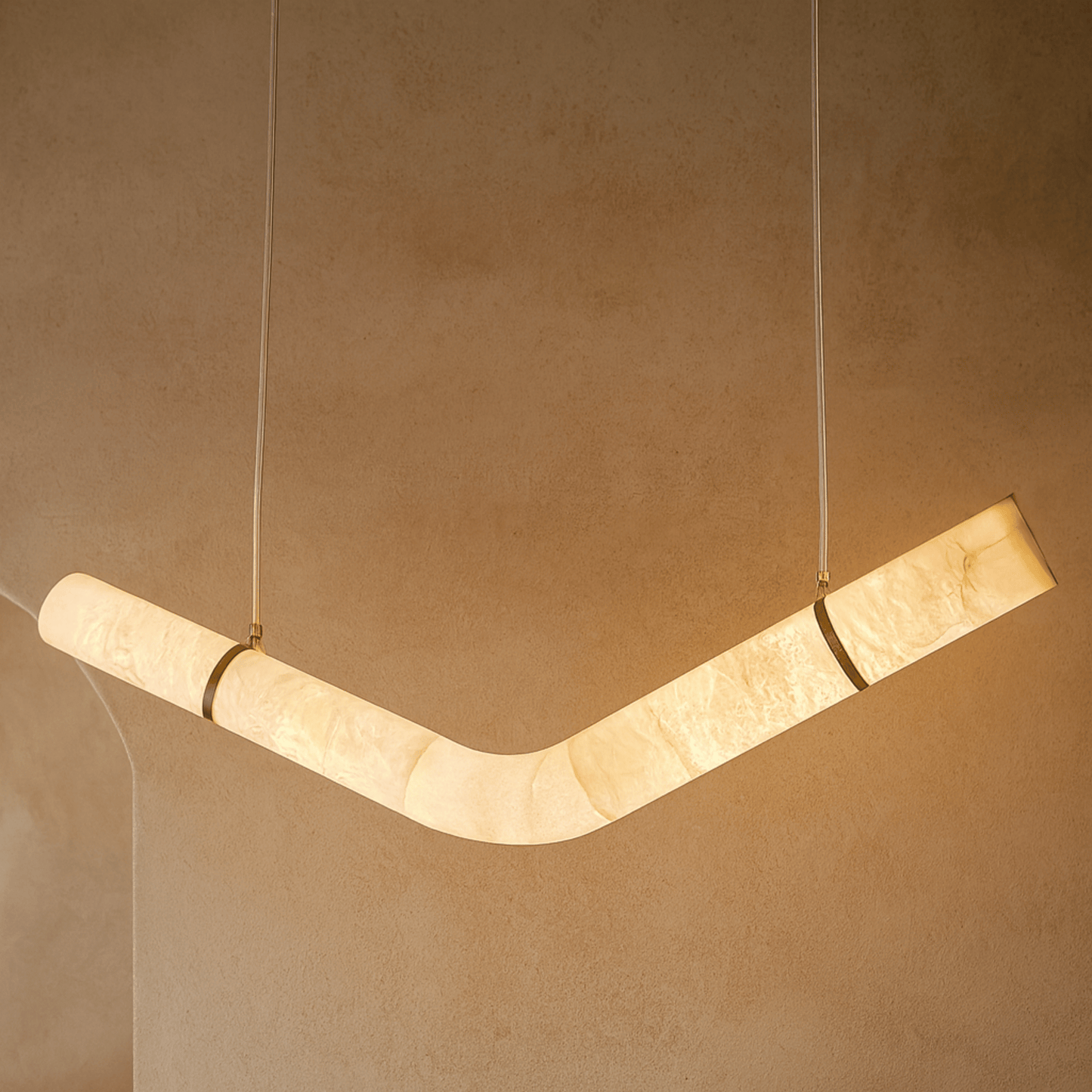 Modern pendant light fixture on a beige wall