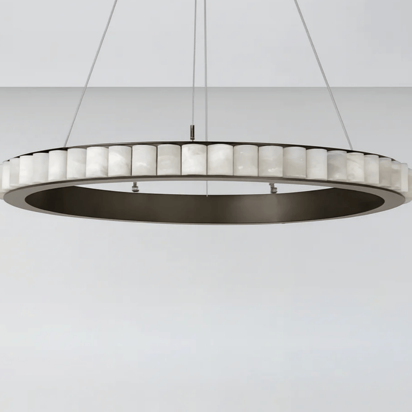 Modern pendant light with circular design on a white background