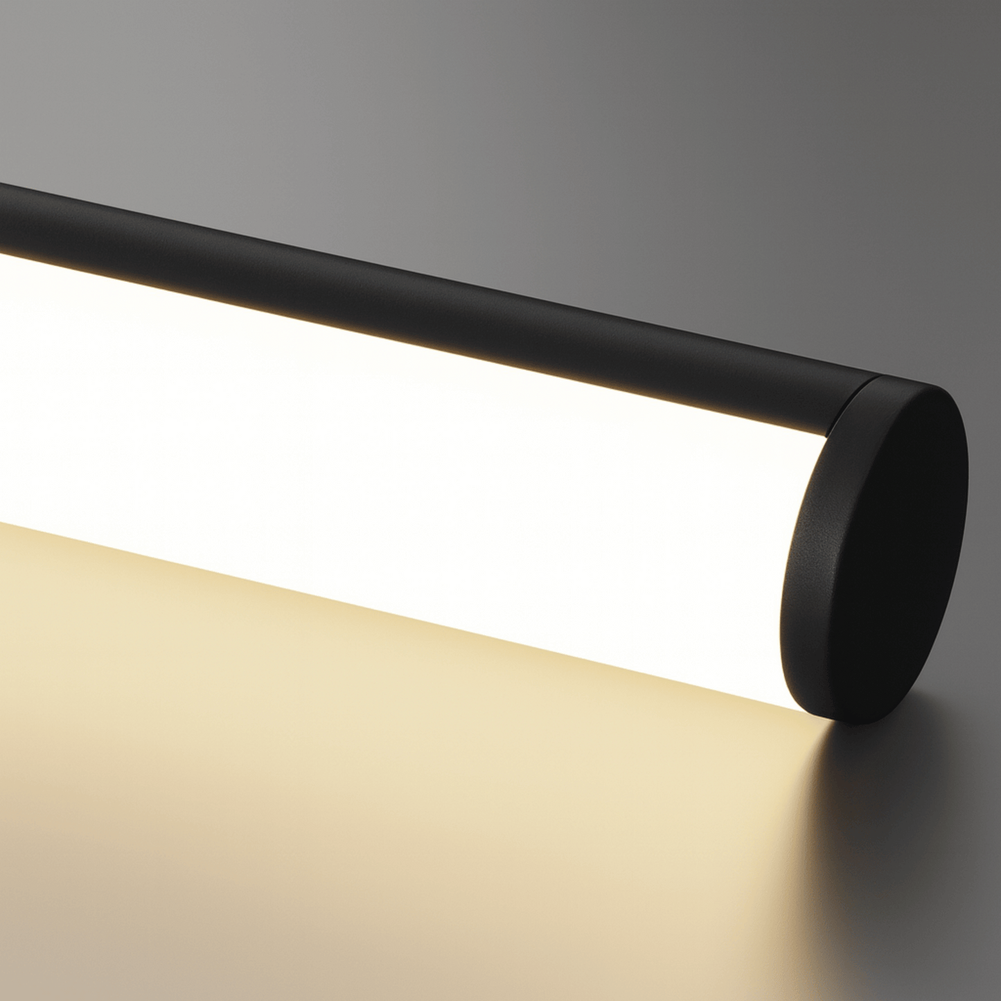 Black cylindrical light fixture on a neutral background