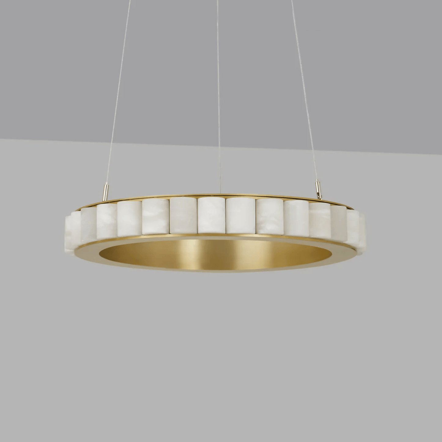 Modern pendant light with gold and white design on a gray background