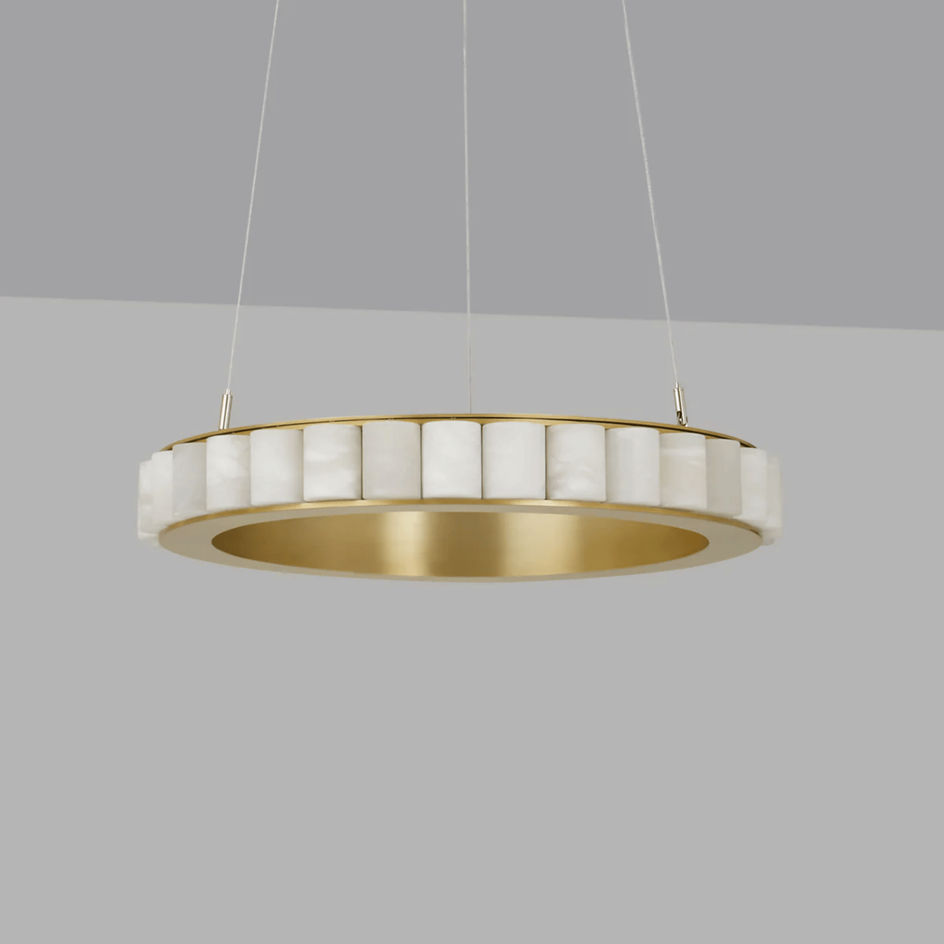 Modern pendant light with gold and white design on a gray background