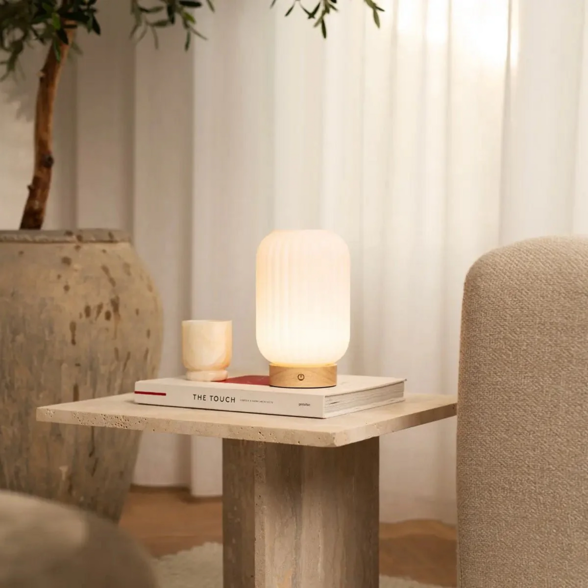 Table lamp on a wooden side table with a cozy indoor setting