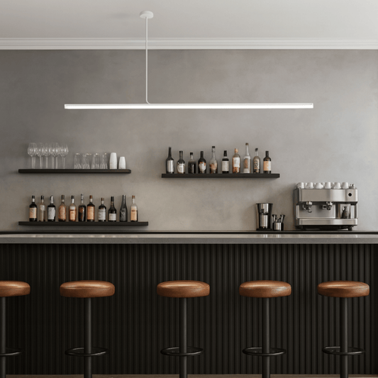 Modern bar setup with shelves, bar stools, and coffee machine against a gray wall.