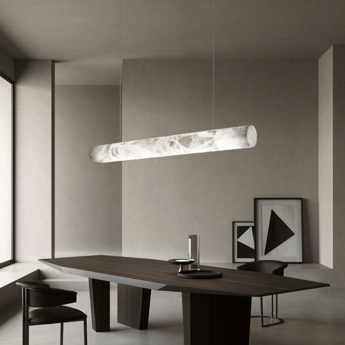 Modern dining room with a long wooden table and pendant light fixture.