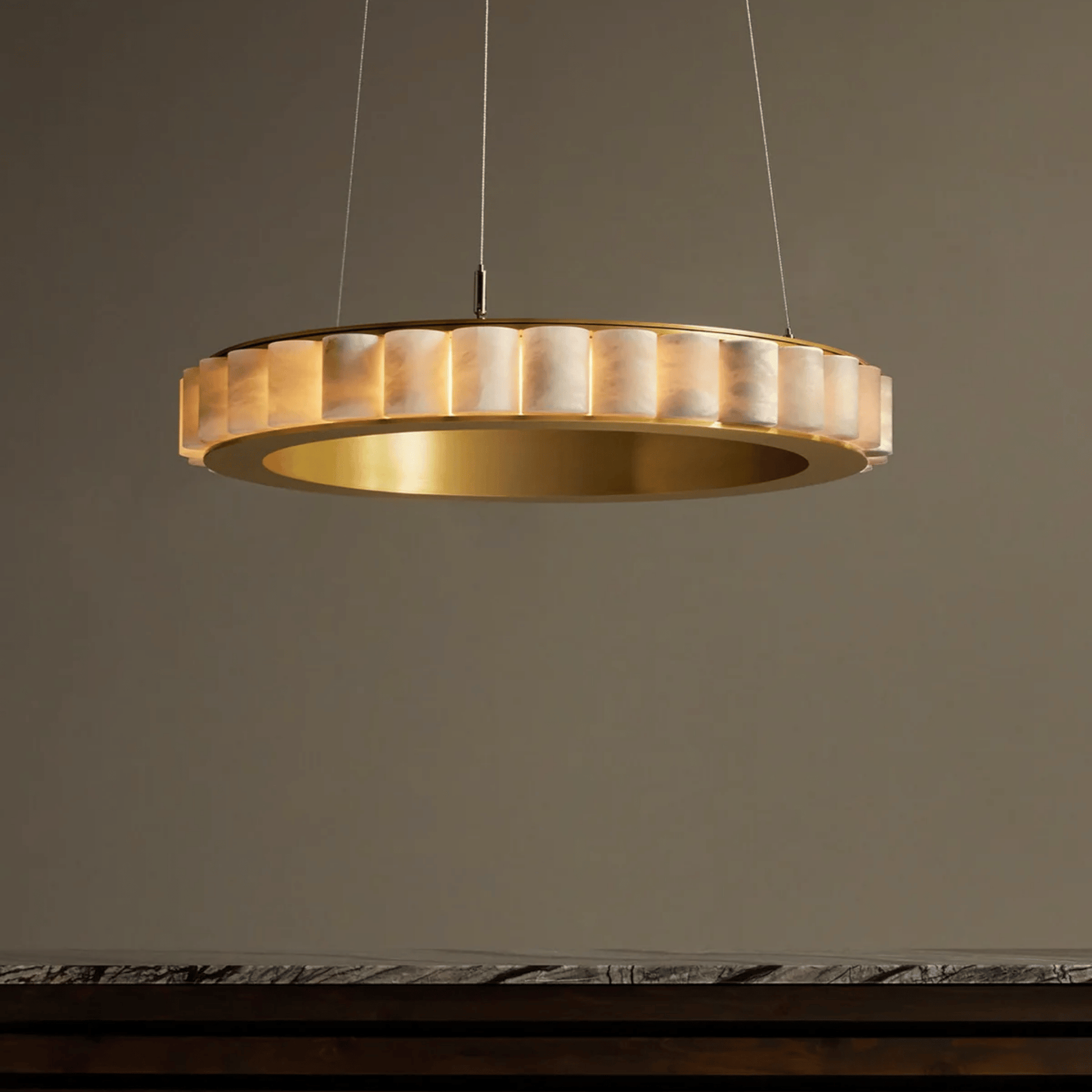 Gold pendant light fixture on a dark background