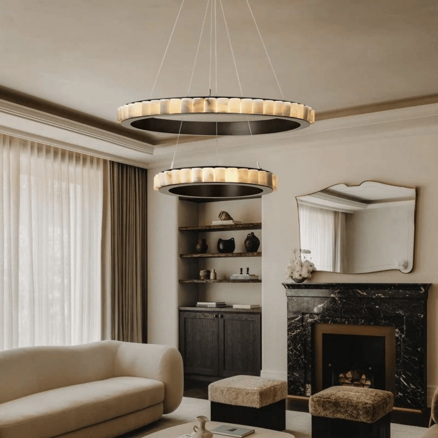 Modern living room with a chandelier, sofa, and fireplace.