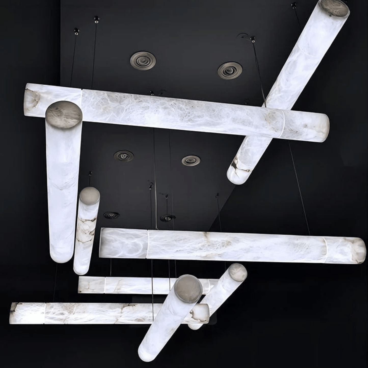 Modern ceiling light fixture with marble-like finish on a black background