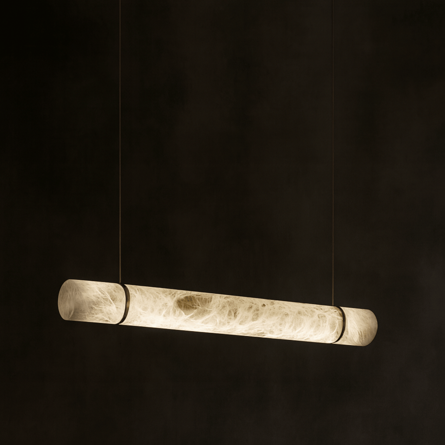 Long cylindrical pendant light on a black background