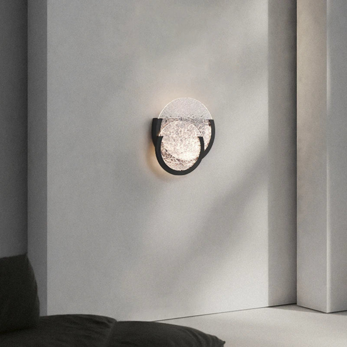 Pair of textured glass wall sconces mounted above a sleek counter in a modern interior.
