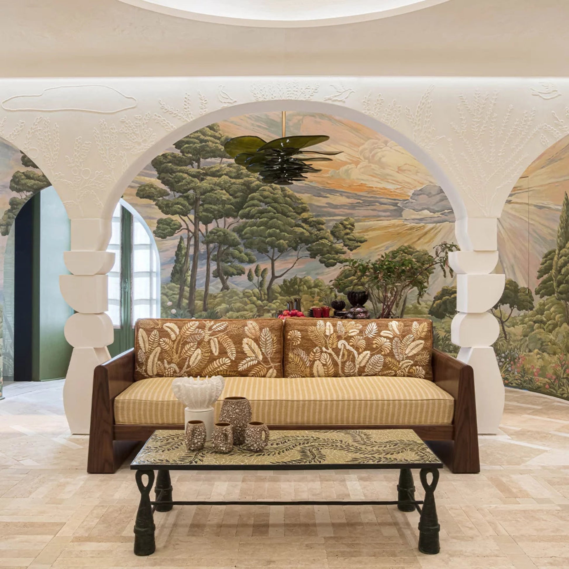 Decorative sofa and coffee table in a room with mural wall art