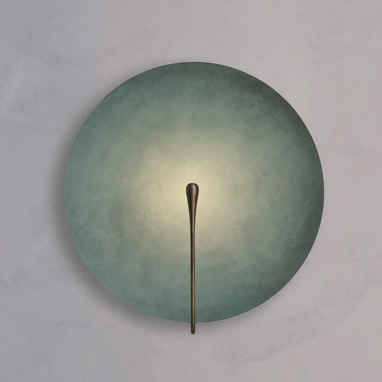 Round wall light fixture with a metallic arm on a gray background