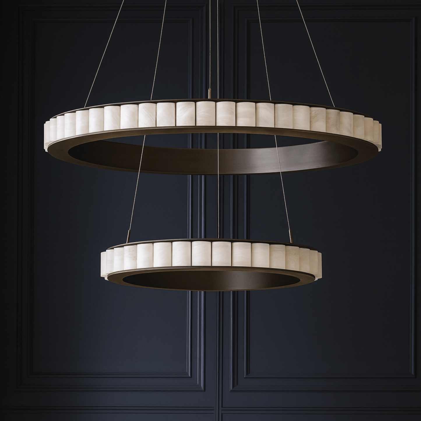 Modern chandelier with two circular designs against a dark background