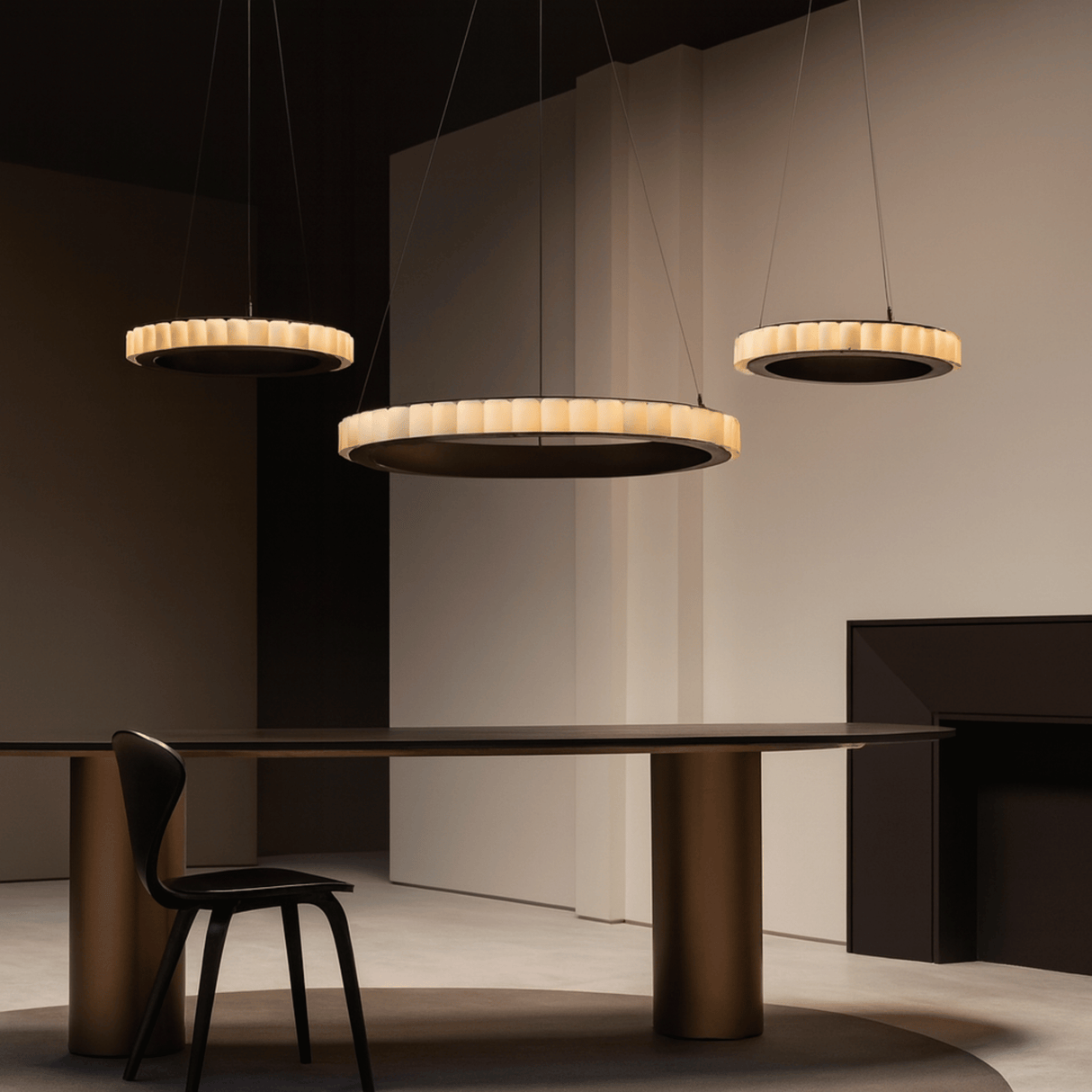 Modern dining room with pendant lights and a table.