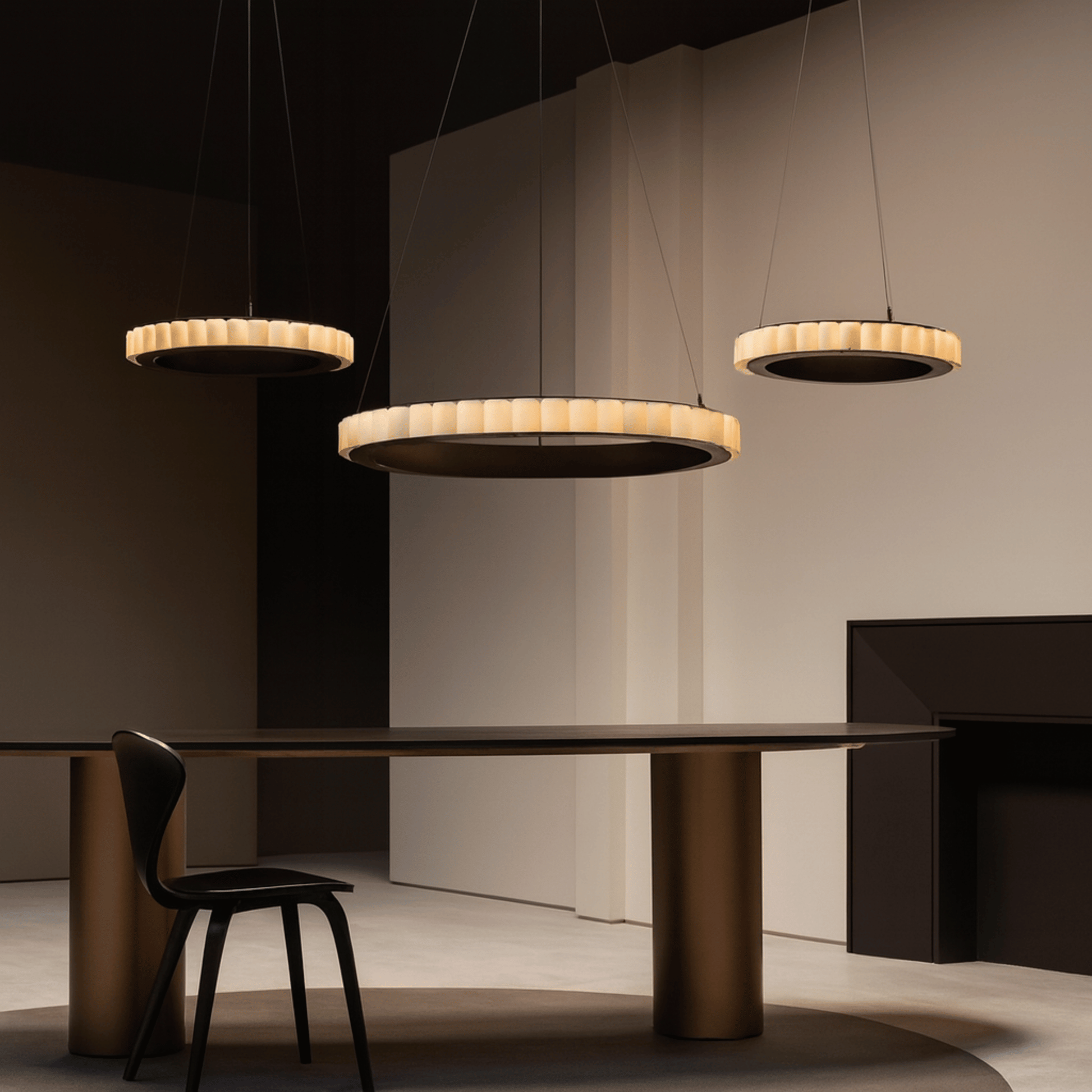 Modern dining room with pendant lights and a table.